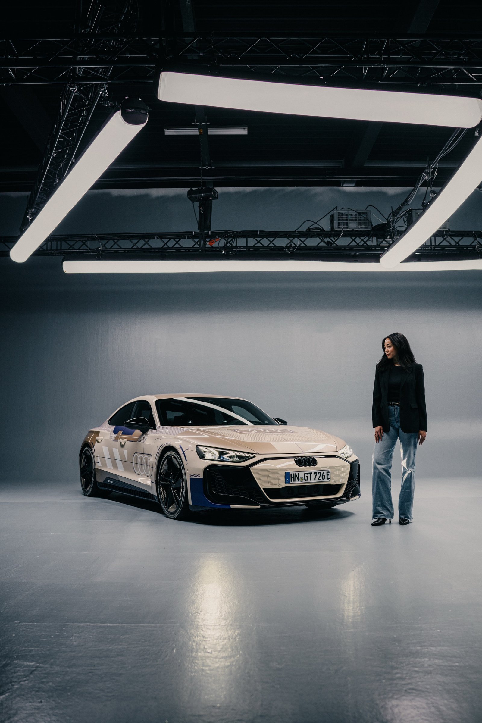 Founder standing next to an Audi show car in a photo studio